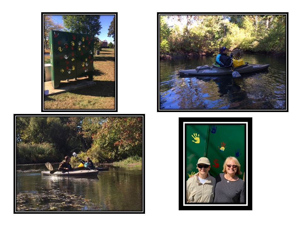 Multiple people Kayaking and standing infront of green wall with various color handprints