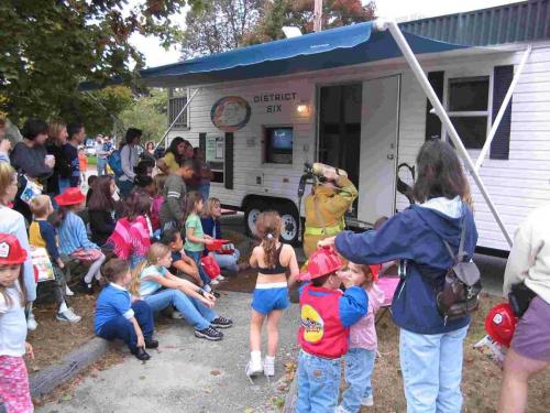 Firefighter putting on oxygen tank