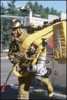 Fire Fighter Hauling Fire Hoses